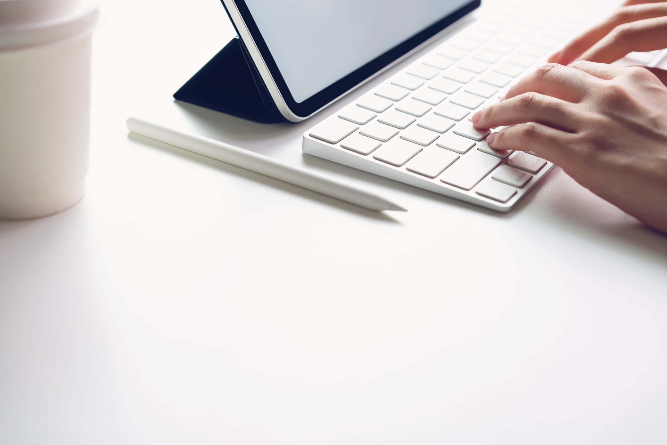 Woman typing keyboard laptop and tablet screen blank on the table mock up to promote your products. Concept of future and trend internet for easy access to information.