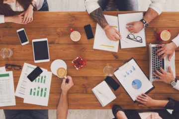 Group of busy business people working in office, top view