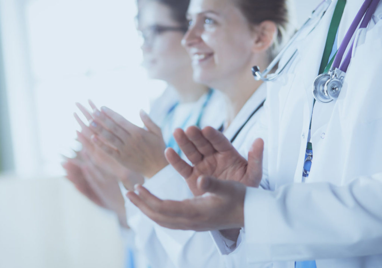 Medical team clapping their hands during a meeting