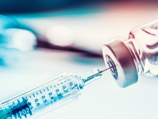 Close-up medical syringe with a vaccine.